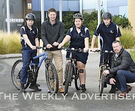 ACTIVE: Horsham Special School students, from left, Dominic Castelman, Ella Massey and Thomas Kennedy, and principal Ben Tait, right, celebrate the school receiving money for bike education programs with Department of Transport Grampians director Michael Bailey. Picture: PAUL CARRACHER