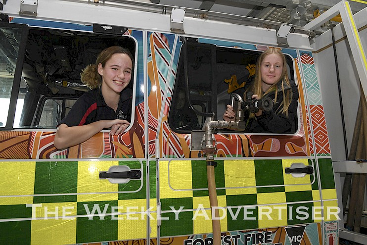 Emily Palmer, Kaniva, and Tessa Leach, Rainbow, try out a Forrest Fire Management truck at the Western Victorian Careers Expo.