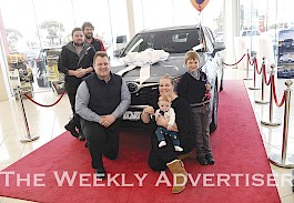 BACK ON THE ROAD: Emily Friedrichsen, and her children Leyton and Liam, pick up keys to a new car, to replace a stolen one, from Horsham Toyota staff members Joel Kelly, front, Tony Cunningham and Billy Elphinstone. Picture: PAUL CARRACHER