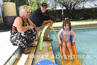 Murtoa Swimming Pool manager Chez Anderson, WIM Resource community liason officer Murray Wilson and Delilah Lesser, 3, get ready for a free family fun day at the pool.