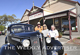 FANS: From left, Bruce Midgley, Chris Niewand and Yvonne Bunton prepare for the 40th anniversary of filming The Flying Doctors television series in Minyip. They are pictured in front of Emma’s Garage with Mr Midgley’s 1937 Buick. Picture: PAUL CARRACHER