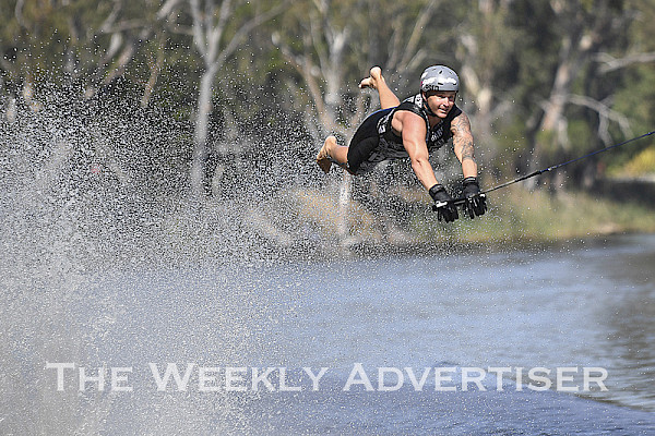 Luke Van Den Heuvel flies off the ramp in the Wimmera River during a heat of the Dimboola Water Ski Tournament and Peter Taylor Barefoot Waterski Memorial night jump on Saturday. Van Den Heuvel went on to win the night jump in front of a wowed crowd. Picture: PAUL CARRACHER