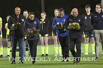 Scott Bond, Angela Ballinger, Ash Hopper and Peter Ballagh lay wreaths at Horsham vs Horsham Saints Anzac Day game.