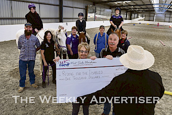 GRATEFUL: Riding For Disabled president Jan Croser accepts $1000 from West Side Horsham representatives Tony Logan and Wimmera Wally. Picture: PAUL CARRACHER