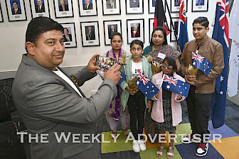 A BETTER LIFE: New citizen Dharminder Kumar takes a photo of Anita and Alisha, visiting from India, and his family Hemlata, Triha Bhangal and Tanisk Kumar at Horsham Civic Centre. Mayor Robyn Gulline swore in 11 new citizens at the ceremony. Picture: PAUL CARRACHER