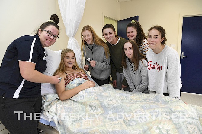 First year certificate two nursing student Maddison O'Neill with St Brigid's College students Maggie Heinrich, Lucy Heinrich, Lotus Martin, Eliza Kirby,  Olivia Howell, front, and Claudia Lanyon at a Try VET day at Fed Uni.