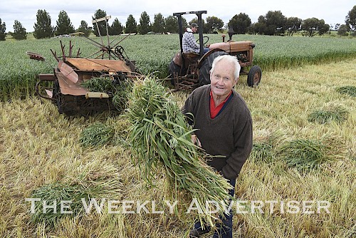 Geoff Inkster, front, and Dale Stephan with a Wheatlands Museum hay binder at Dunmukle Sump Oilers display during Murtoa's Big Weekend.