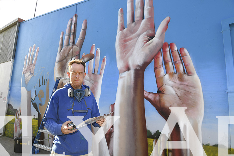 Artist Daniel Venn working on a mural at the Centre For Participation in Horsham.