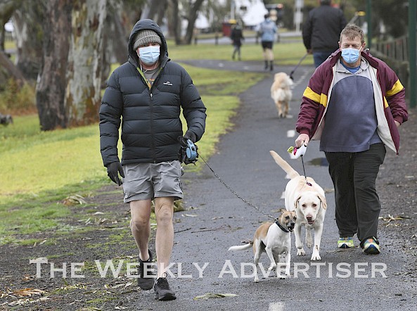 Grant Robertson and Huey and Glen Rigby with Lola walking along the Wimmera river in Horsham.